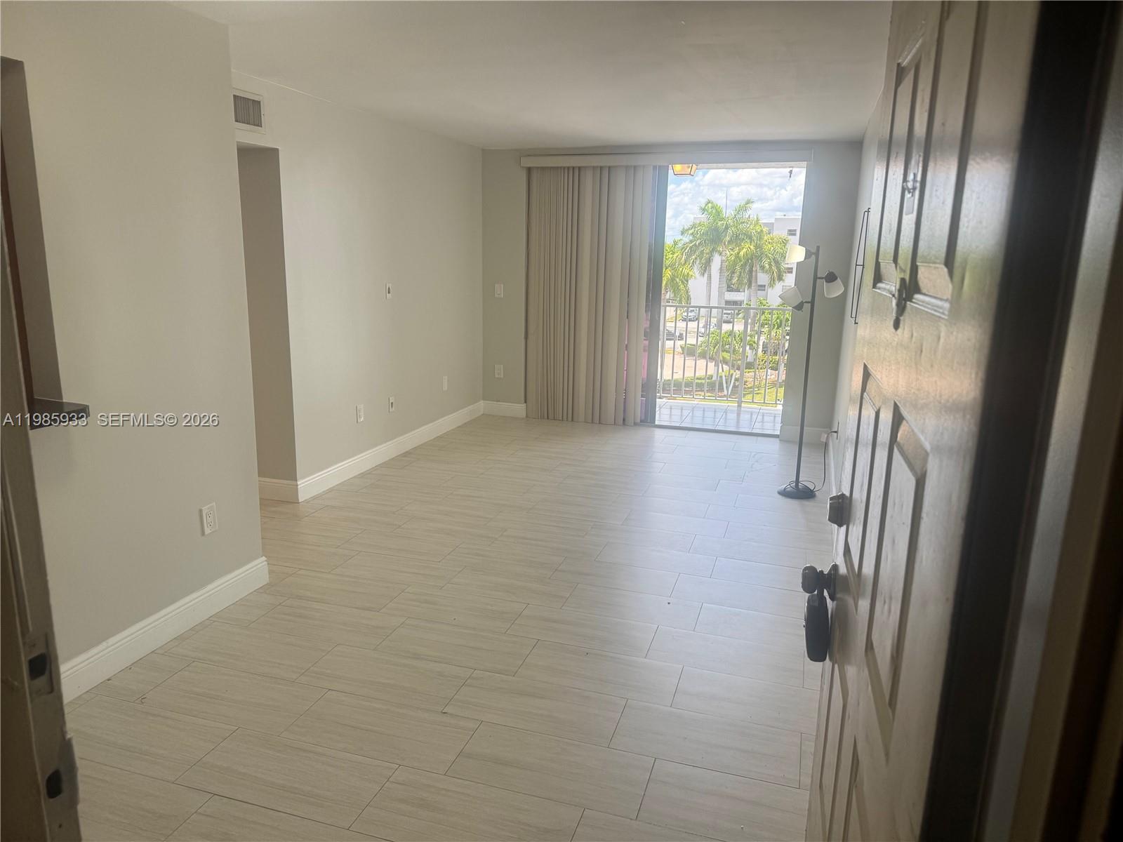 8075 Northwest 7th Street, Unit 403 Miami, FL 33126 - Photo 14 of 29 a view of livingroom with hardwood floor and window