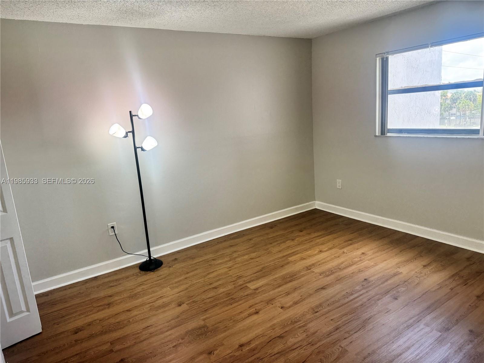 8075 Northwest 7th Street, Unit 403 Miami, FL 33126 - Photo 20 of 29 a view of a room with wooden floor and a window