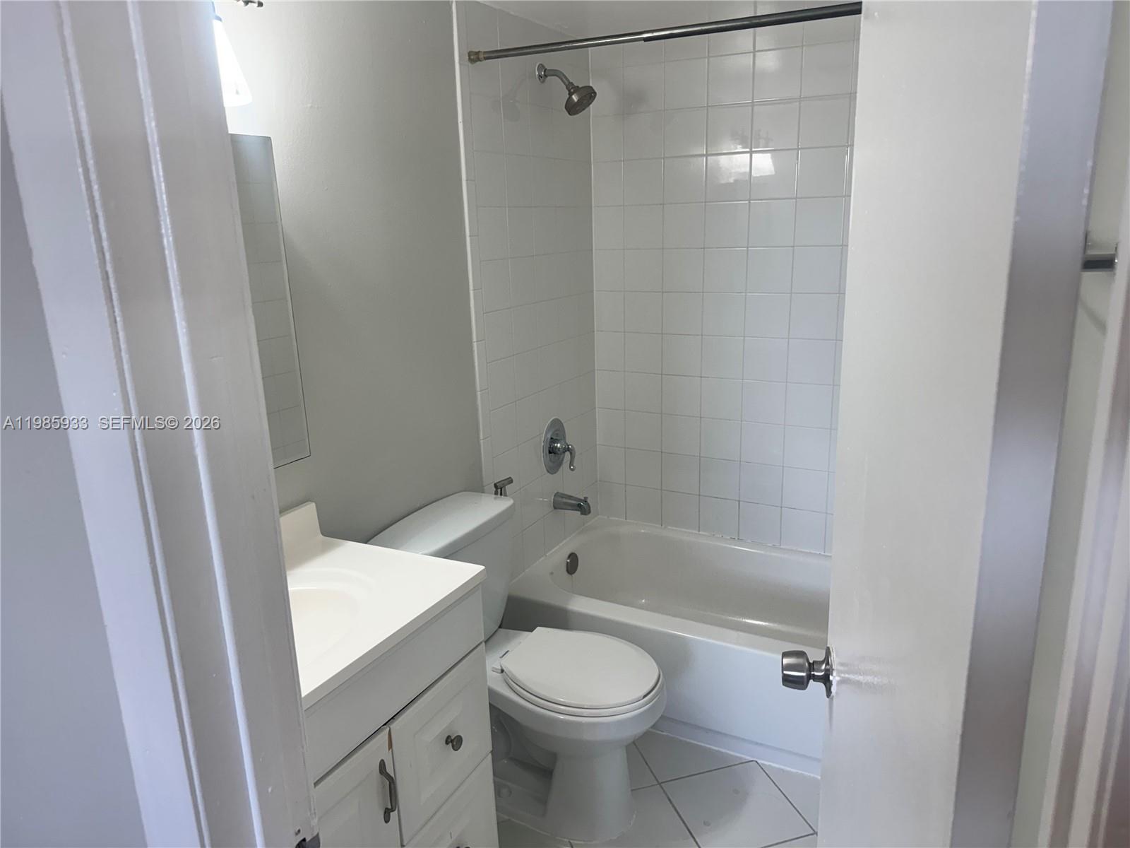 8075 Northwest 7th Street, Unit 403 Miami, FL 33126 - Photo 21 of 29 a bathroom with a sink toilet and shower