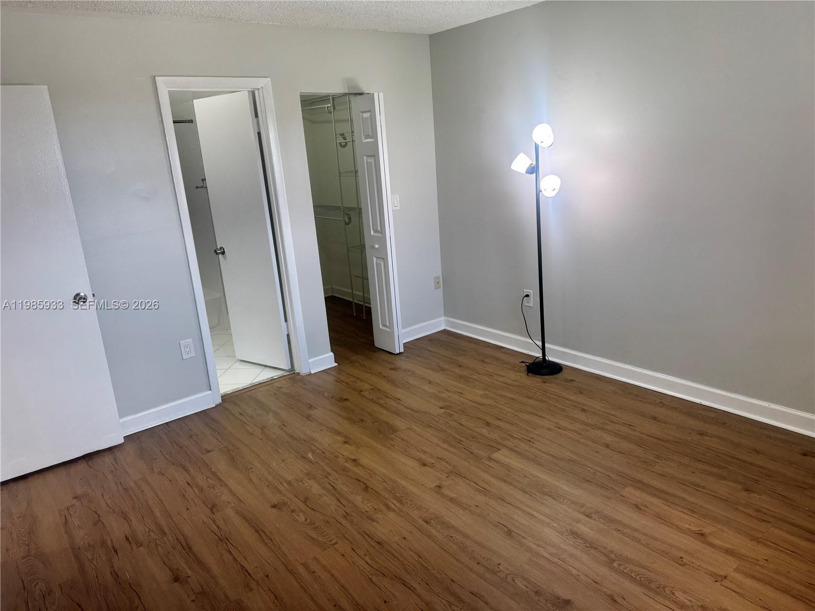 8075 Northwest 7th Street, Unit 403 Miami, FL 33126 - Photo 22 of 29 an empty room with wooden floor and entrance