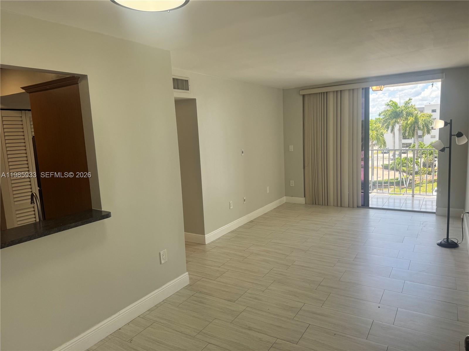 8075 Northwest 7th Street, Unit 403 Miami, FL 33126 - Photo 23 of 29 a view of an empty room with glass door