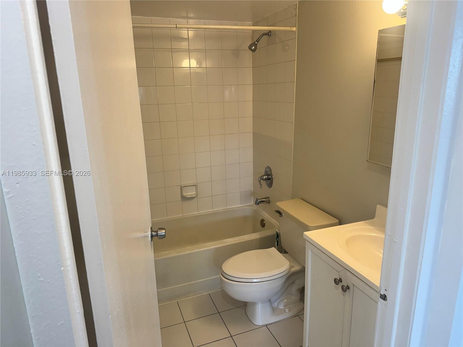 8075 Northwest 7th Street, Unit 403 Miami, FL 33126 - Photo 24 of 29 a bathroom with a sink a toilet and shower