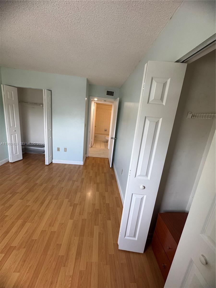 8075 Northwest 7th Street, Unit 403 Miami, FL 33126 - Photo 6 of 29 a view of front door with wooden floor