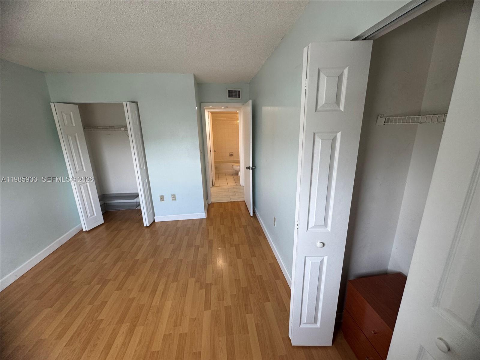 8075 Northwest 7th Street, Unit 403 Miami, FL 33126 - Photo 7 of 29 a view of a hallway with wooden floor and staircase