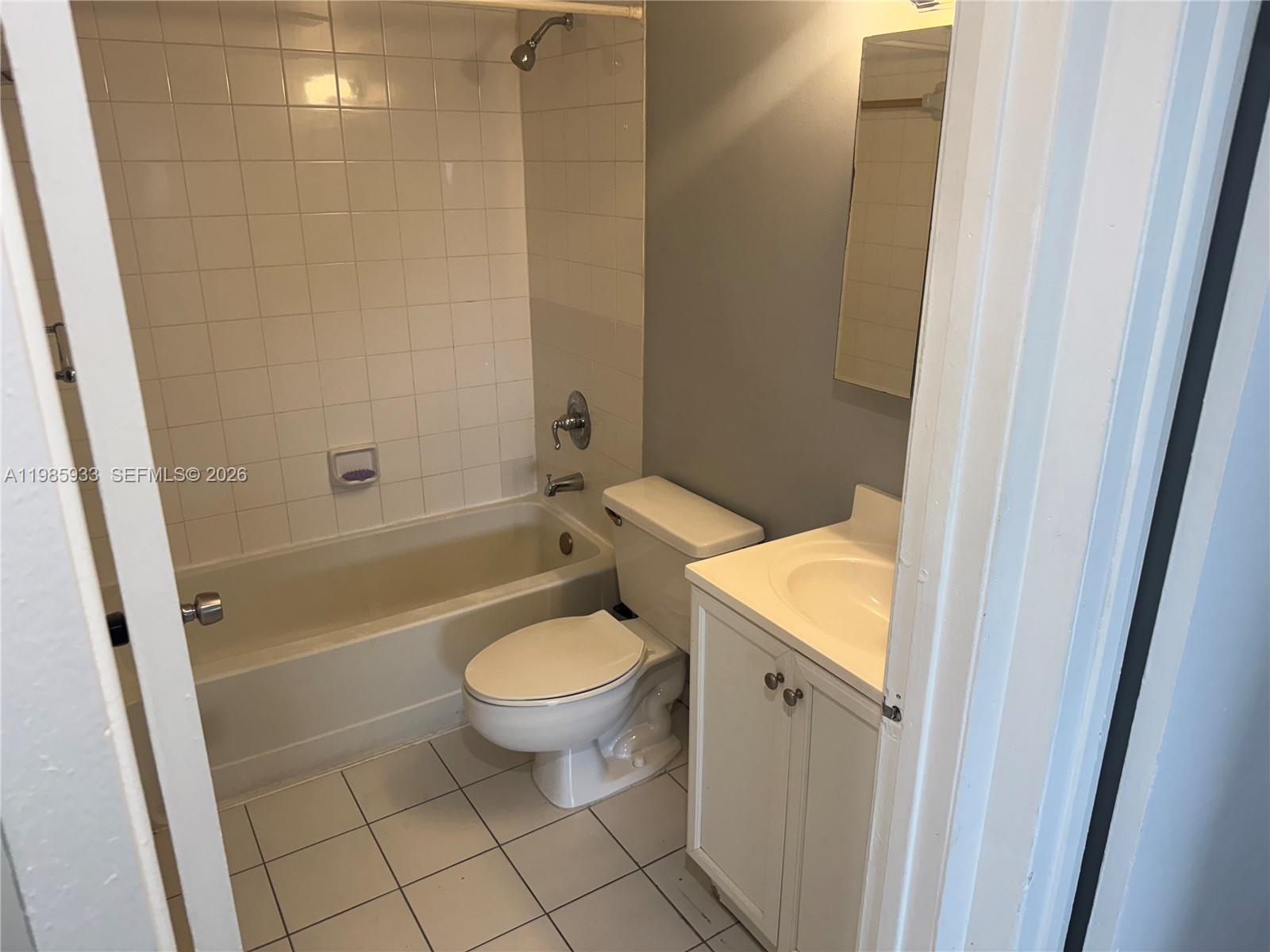 8075 Northwest 7th Street, Unit 403 Miami, FL 33126 - Photo 8 of 29 a bathroom with a sink toilet and shower