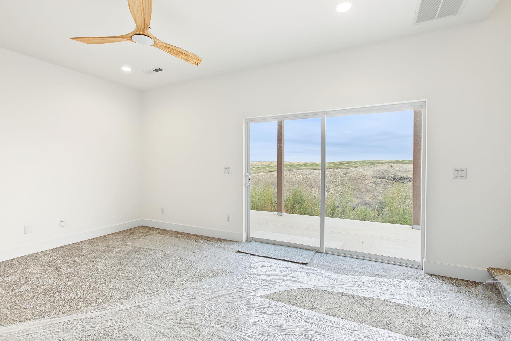 3217 Hidden Valley Loop Lewiston, ID 83501 - Photo 47 of 50 Covered concrete patio with wood-finish supports and ceiling, overlooking expansive natural scenery