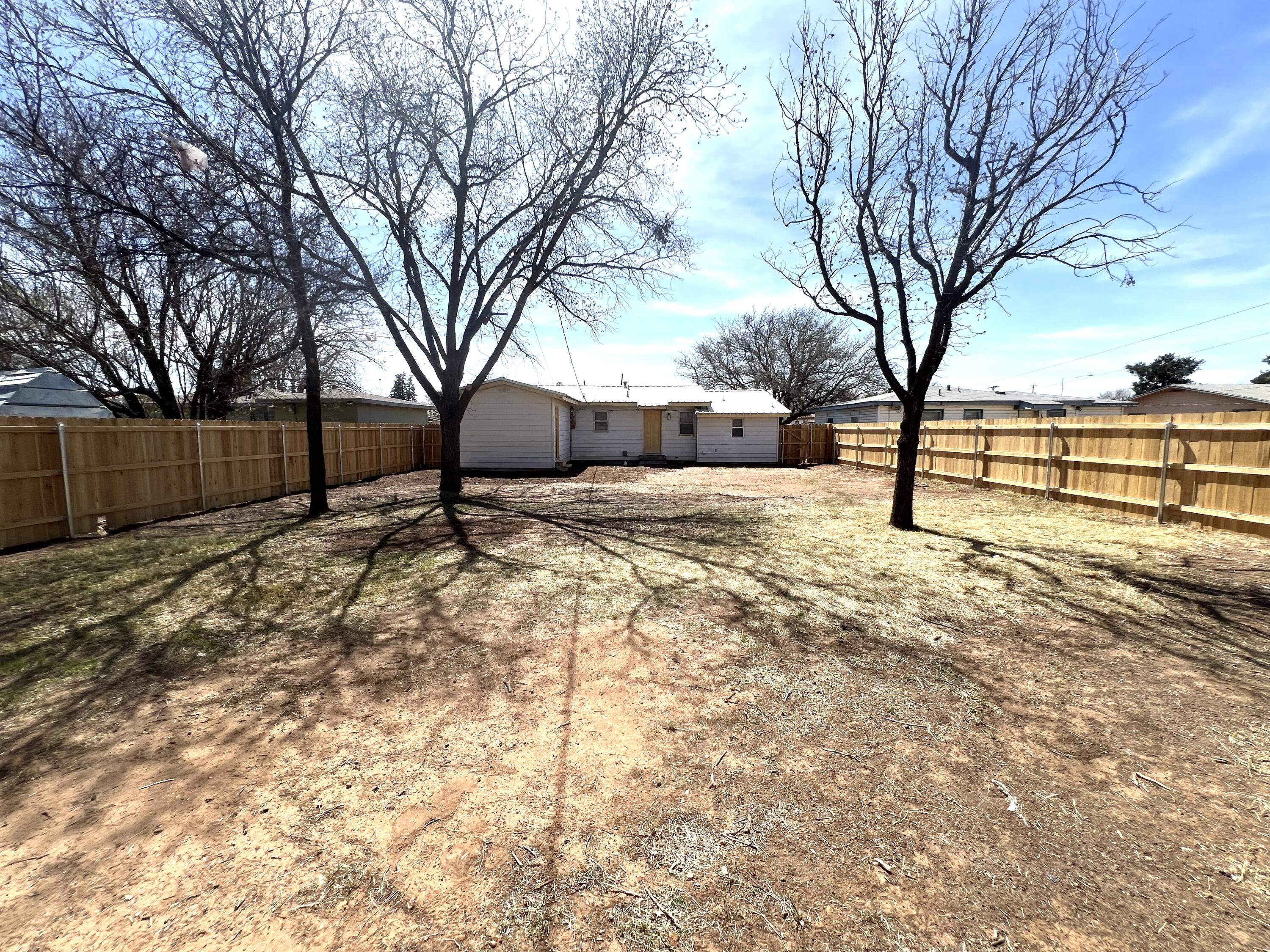 1910 64th Street Lubbock, TX 79412 - Photo 11 of 18 a view of a yard with a tree