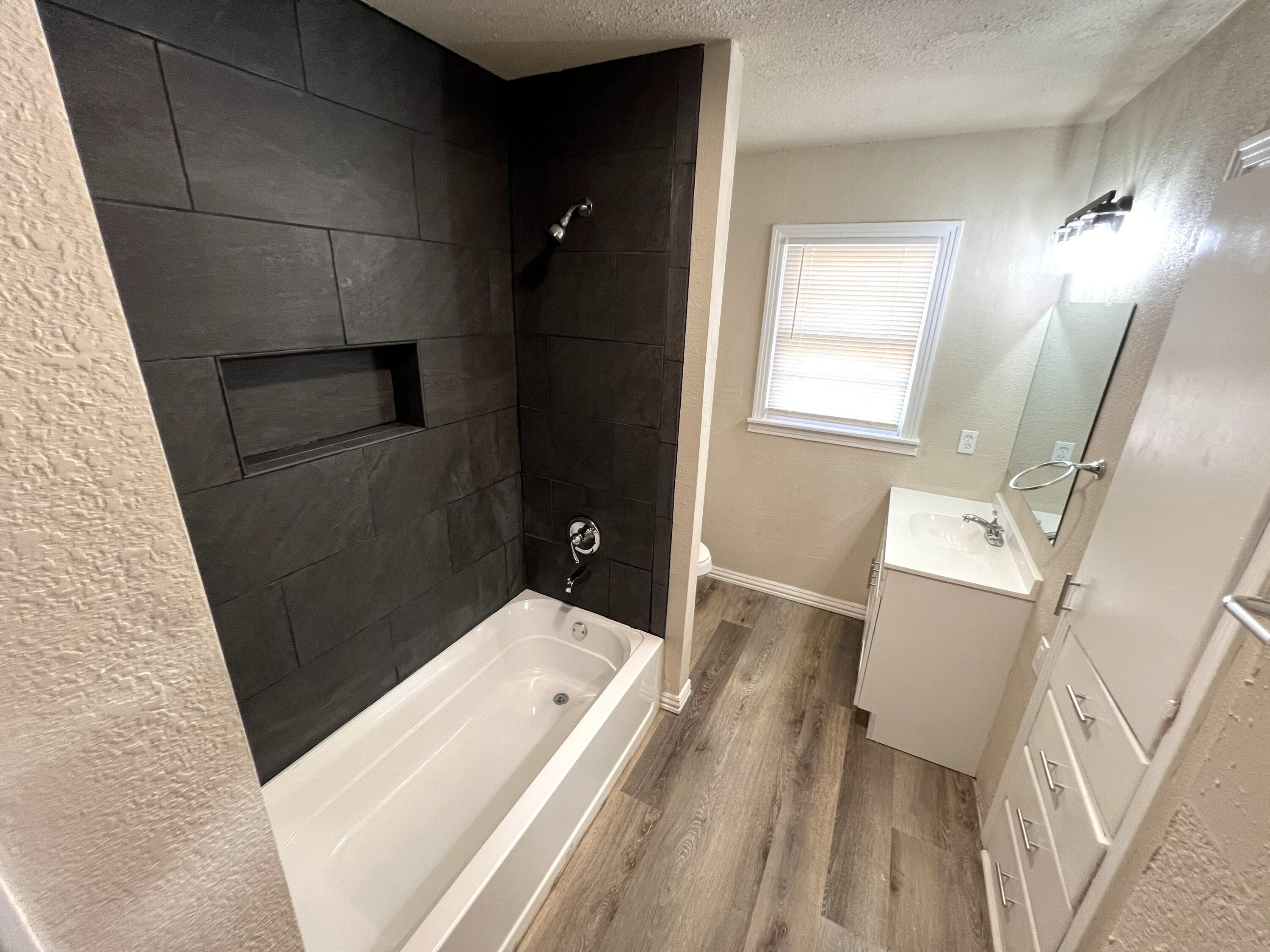 1910 64th Street Lubbock, TX 79412 - Photo 14 of 18 a bathroom with a sink and mirror