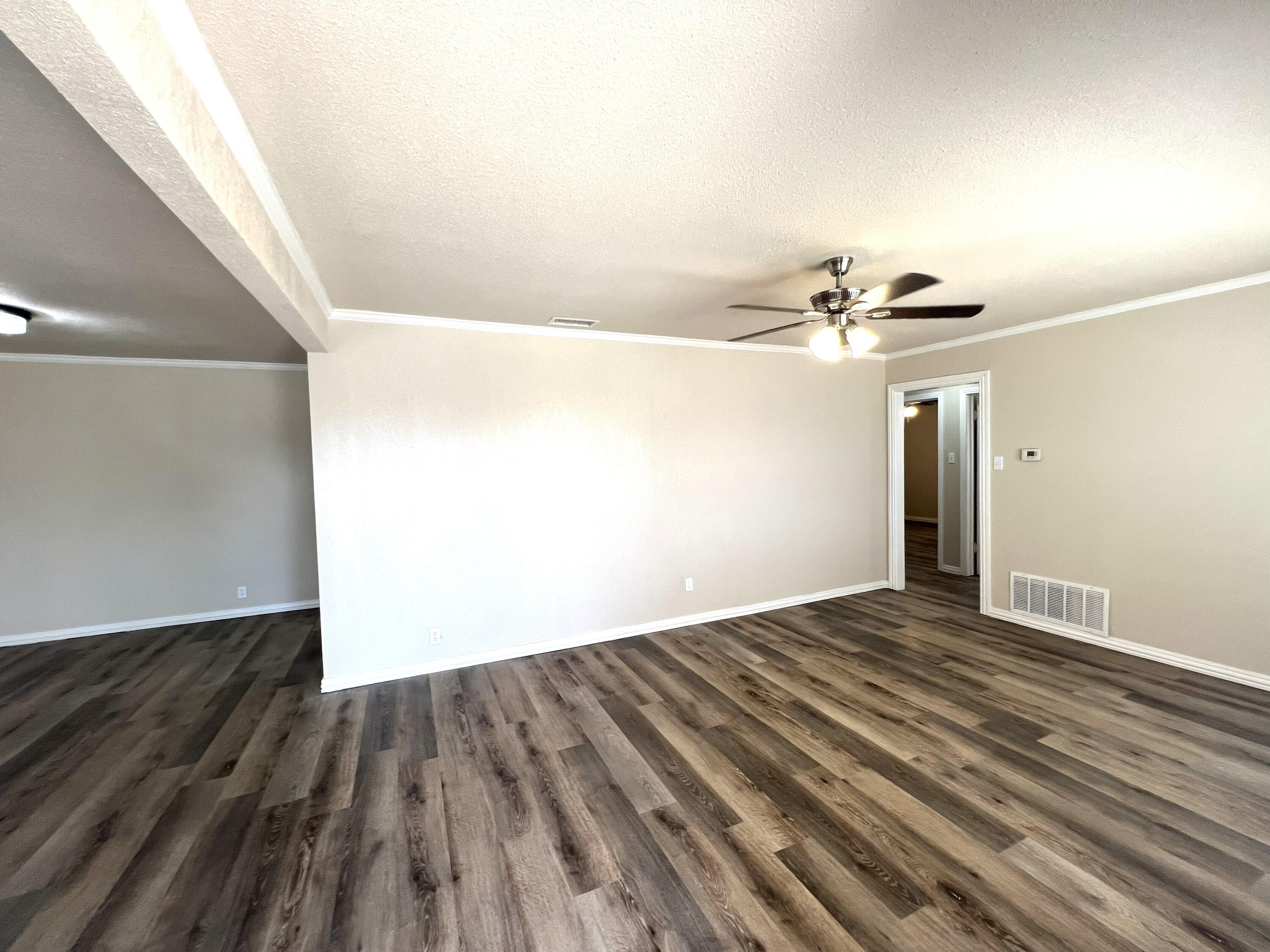1910 64th Street Lubbock, TX 79412 - Photo 3 of 18 a view of empty room with wooden floor