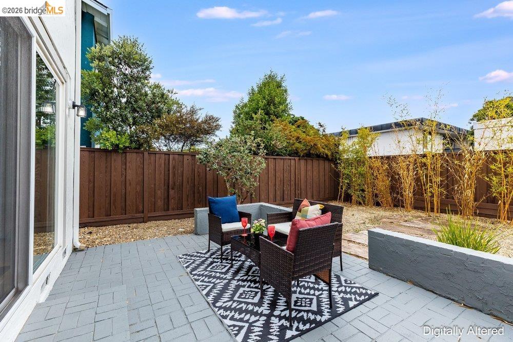 1298 Ribbon Street Foster City, CA 94404 - Photo 77 of 86 Paved patio area featuring gray pavers, a perimeter privacy fence, and integrated planter boxes