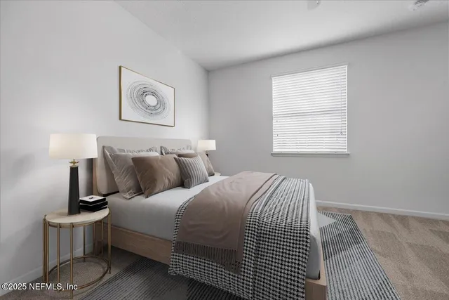 a bedroom with a bed and painting on the wall