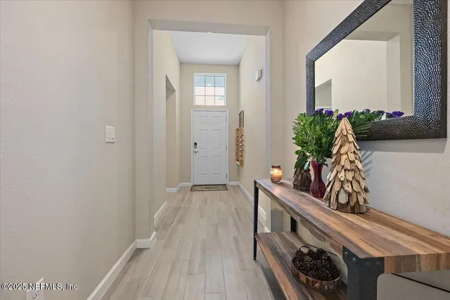 a view of hallway with wooden floor