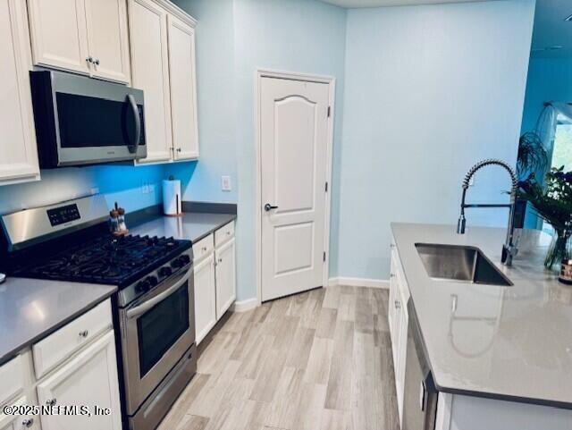 102 Anguilla Boulevard St. Augustine, FL 32092 - Photo 7 of 24 a kitchen with stainless steel appliances granite countertop a stove a sink and a microwave
