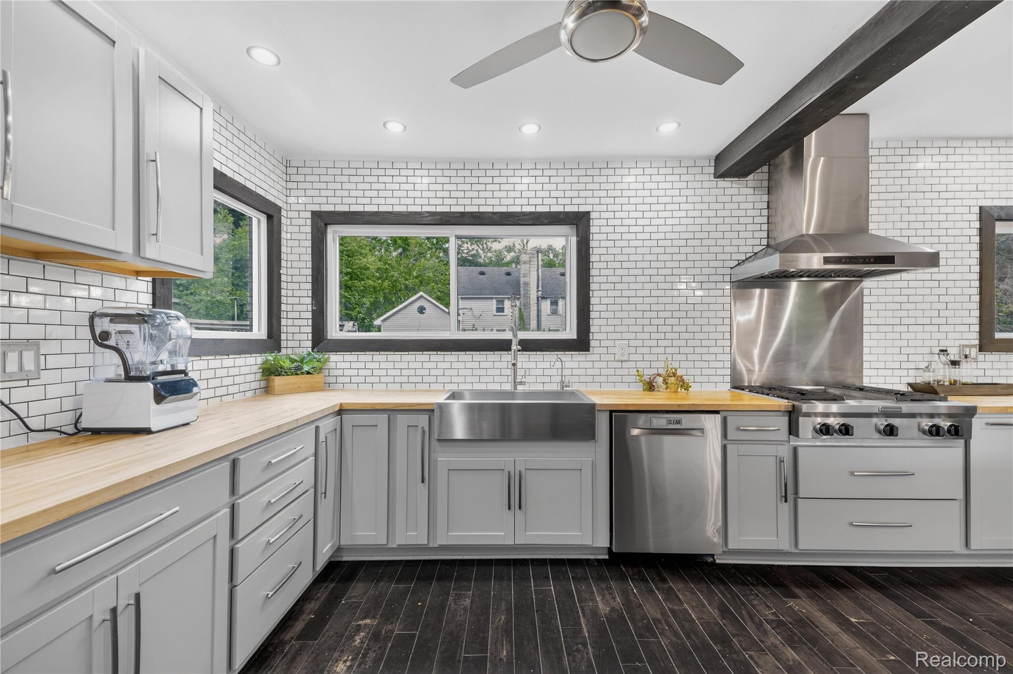 4860 Blue Bush Road Monroe, MI 48162 - Photo 13 of 59 Modern kitchen featuring light gray cabinetry, wood-finish countertops, and a white subway tile backsplash