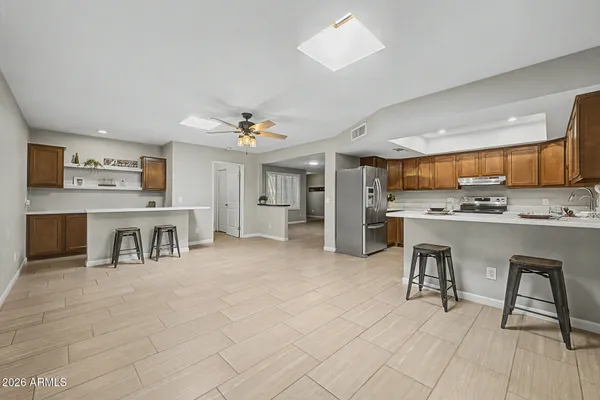 a kitchen with cabinets and chairs