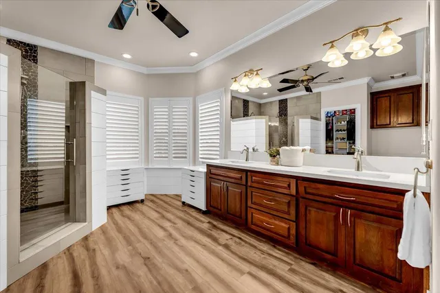 a spacious bathroom with a double vanity sink a large mirror and a bathtub