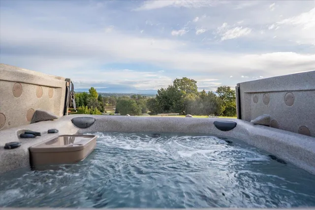a view of a terrace with furniture and city view