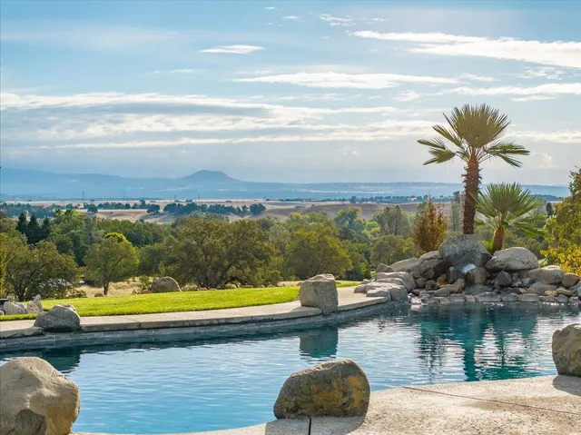 a view of swimming pool with outdoor seating and yard in back