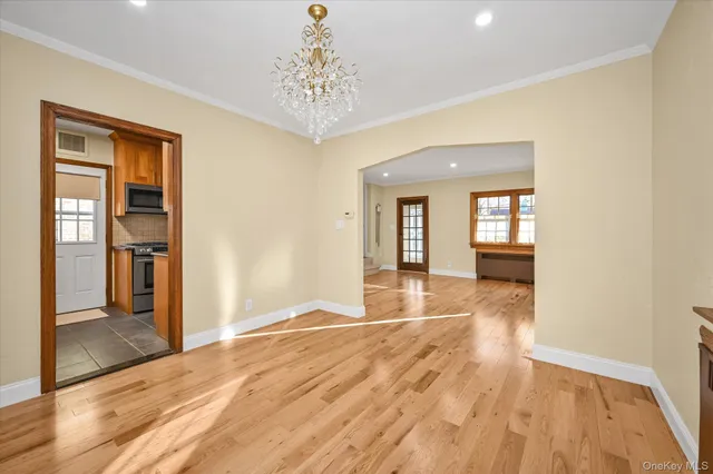 a view of livingroom with hardwood floor and kitchen view