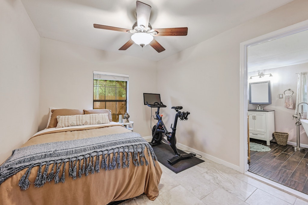 4025 Valley View Road, Unit 2 Austin, TX 78704 - Photo 15 of 19 a bedroom with a bed and a chandelier