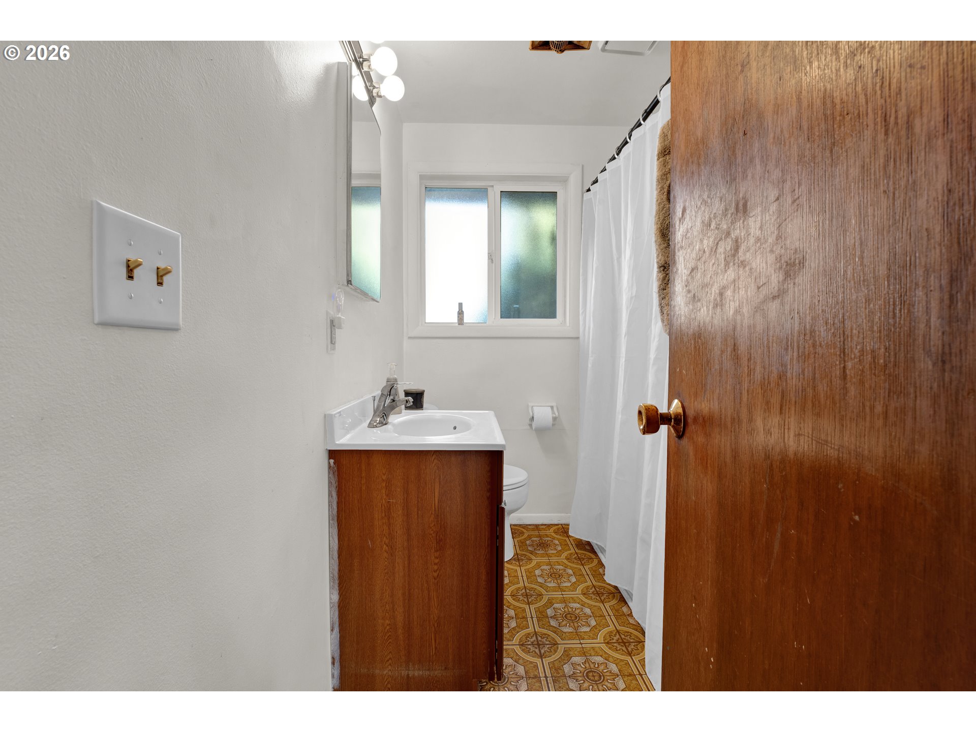 3307 Arrowhead Street Eugene, OR 97404 - Photo 14 of 46 a bathroom with a sink and mirror with toilet