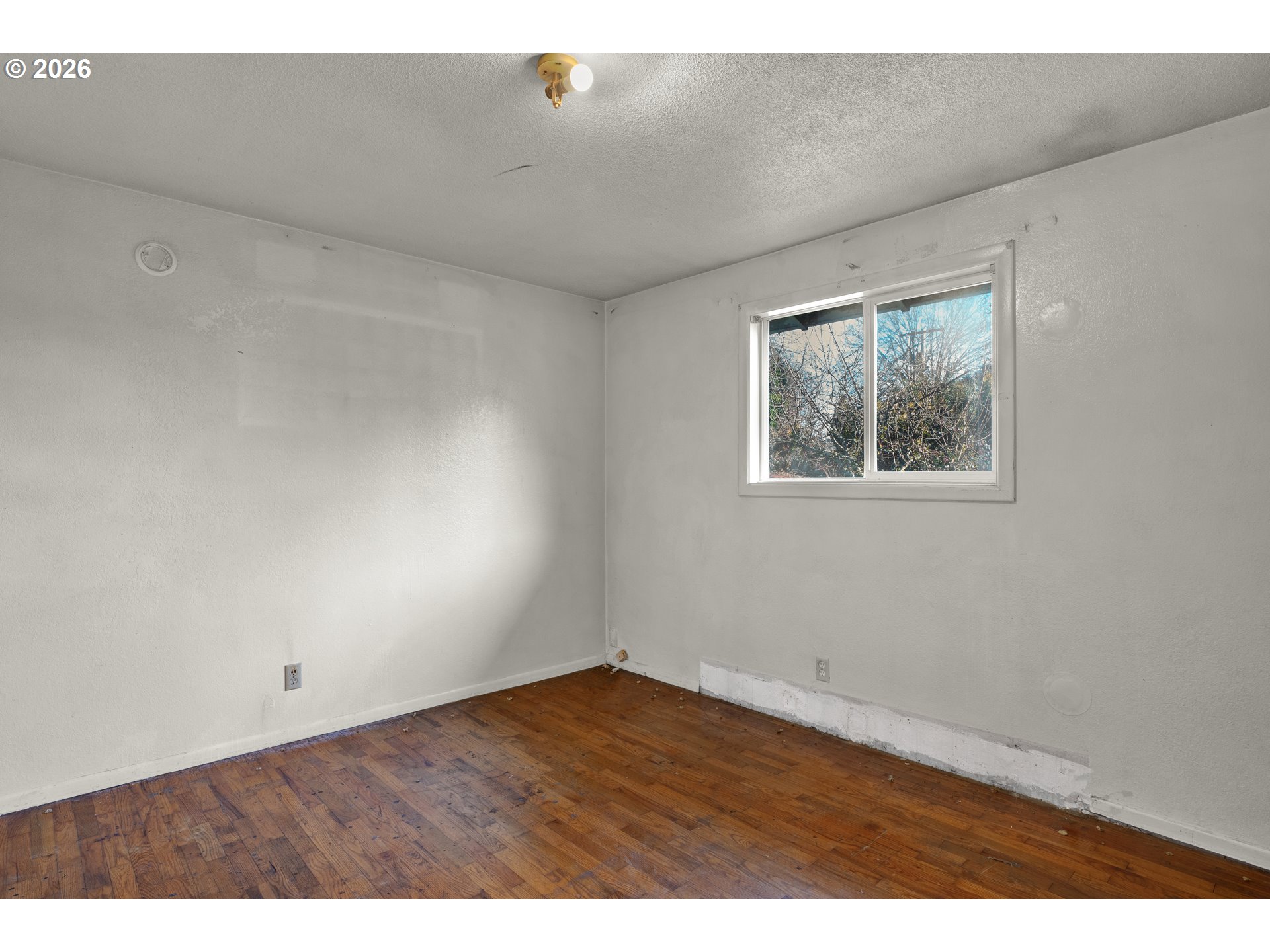 3307 Arrowhead Street Eugene, OR 97404 - Photo 28 of 46 a view of an empty room with wooden floor and a window