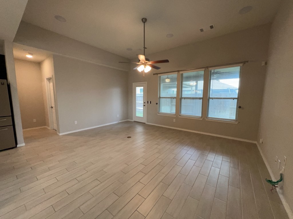 5135 Emma Forest Street Houston, TX 77018 - Photo 11 of 28 an empty room with wooden floor and windows