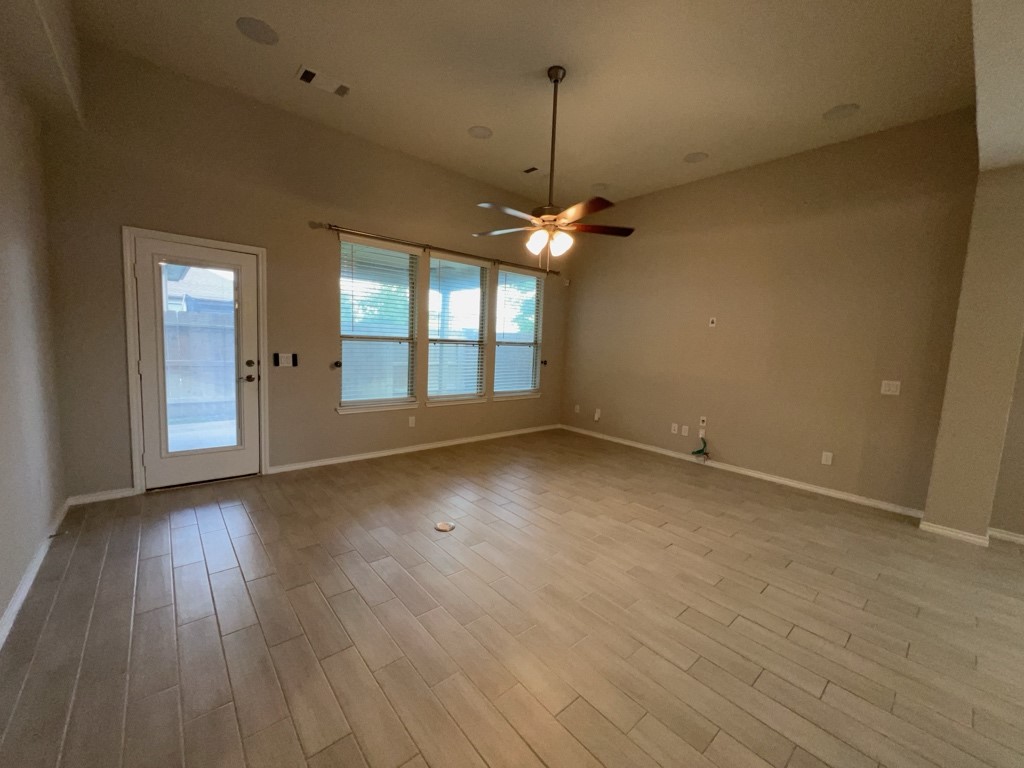 5135 Emma Forest Street Houston, TX 77018 - Photo 12 of 28 an empty room with wooden floor and windows