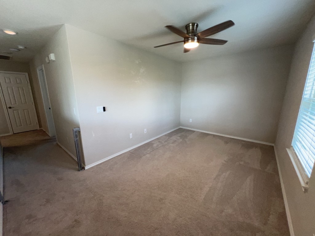 5135 Emma Forest Street Houston, TX 77018 - Photo 14 of 28 an empty room with closet and ceiling fan