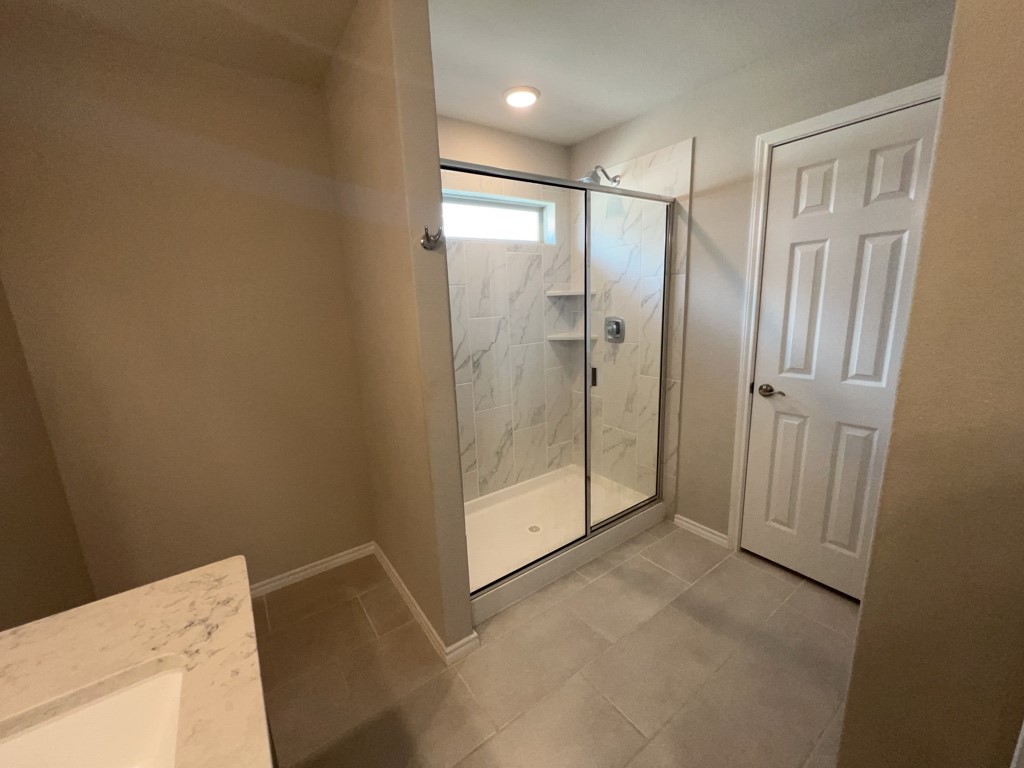 5135 Emma Forest Street Houston, TX 77018 - Photo 20 of 28 a spacious bathroom with a glass shower door