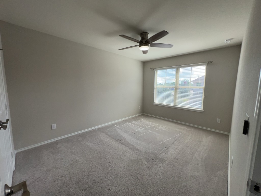 5135 Emma Forest Street Houston, TX 77018 - Photo 21 of 28 an empty room with windows and ceiling fan