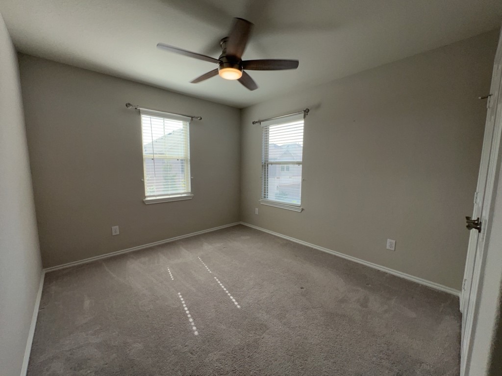 5135 Emma Forest Street Houston, TX 77018 - Photo 22 of 28 an empty room with a window and a fan