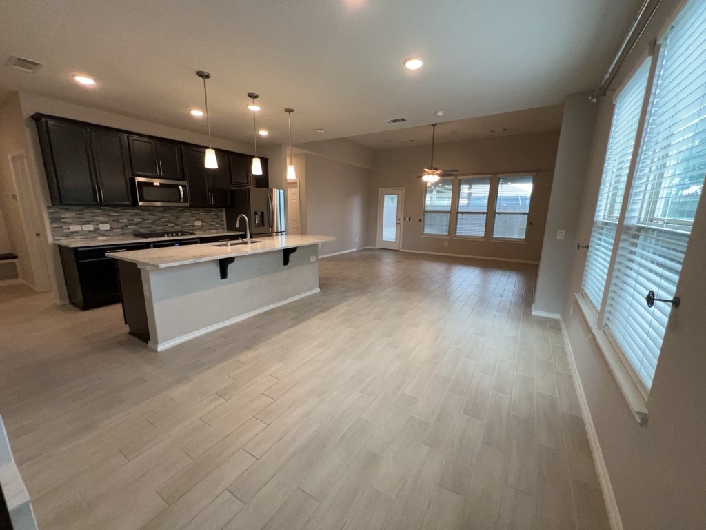 5135 Emma Forest Street Houston, TX 77018 - Photo 3 of 28 a large white kitchen with a large window