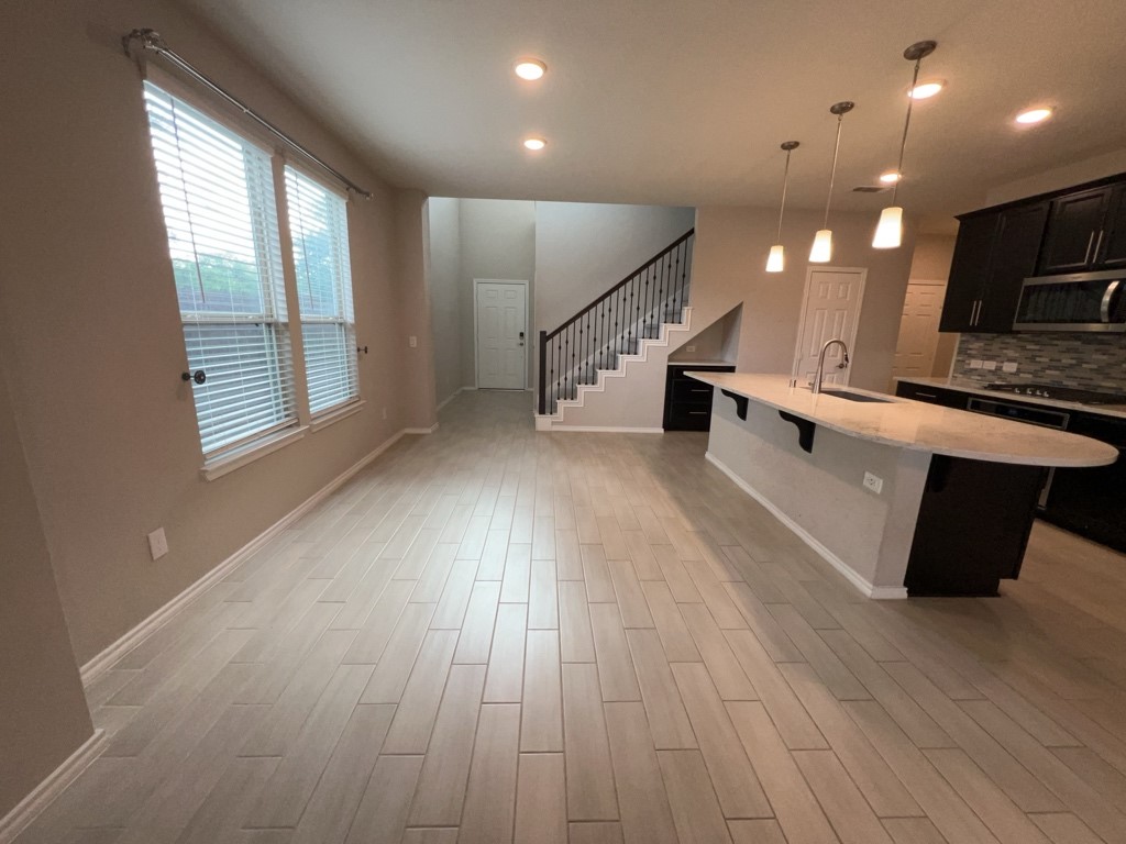 5135 Emma Forest Street Houston, TX 77018 - Photo 4 of 28 an empty room with wooden floor and windows