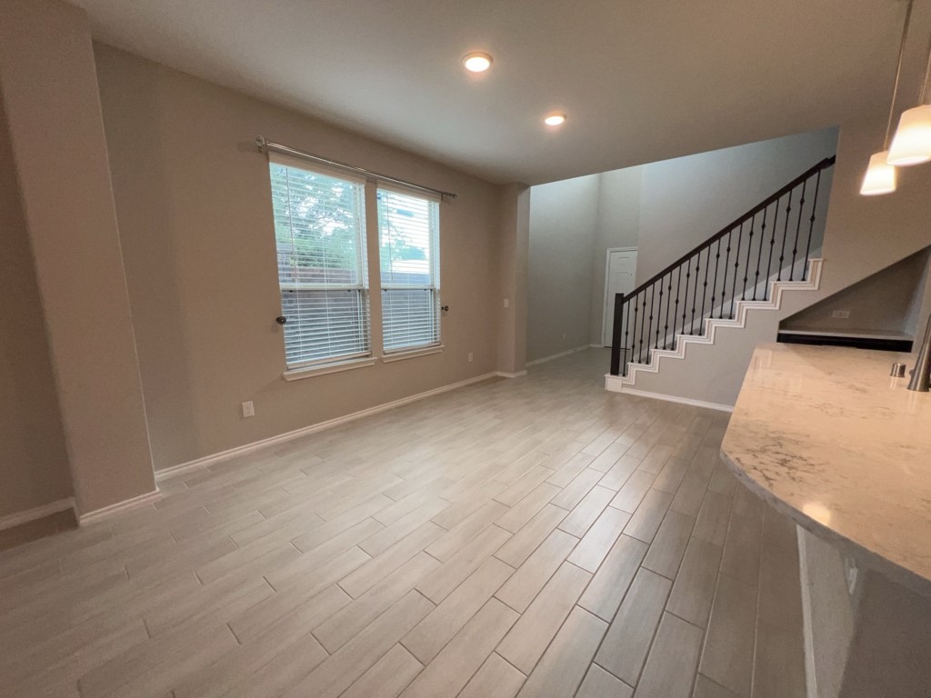 5135 Emma Forest Street Houston, TX 77018 - Photo 5 of 28 a view of an empty room with wooden floor and a window