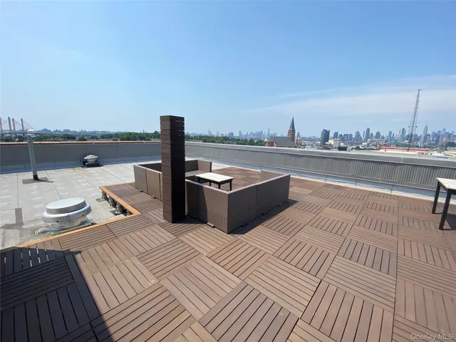 a view of a terrace with wooden floor and seating space