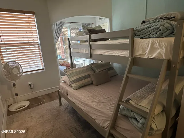a bed sitting in a bedroom next to a window