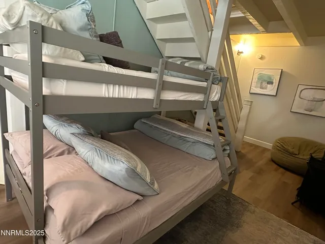 a bed sitting in a bedroom next to a window