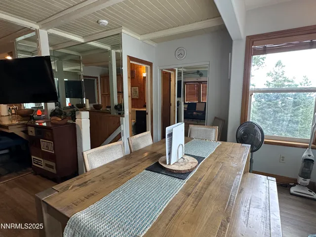 a dining room with wooden floor and furniture