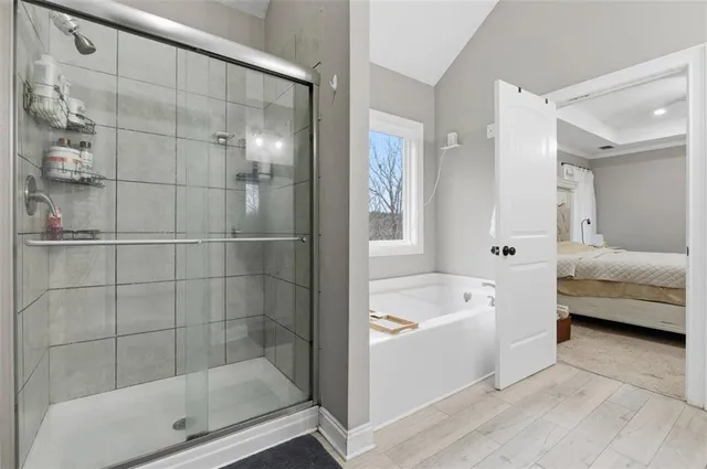 a bathroom with a tub shower and sink