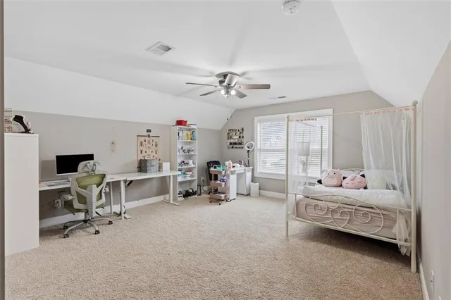 a bedroom with furniture and a large window