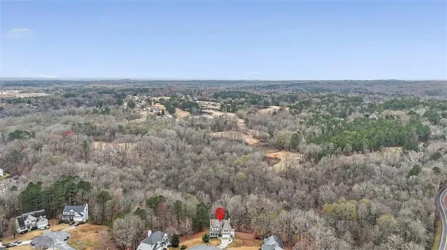 an aerial view of a houses with trees