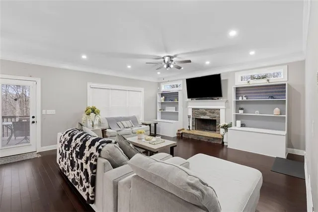 a bedroom with furniture a fireplace and a flat screen tv
