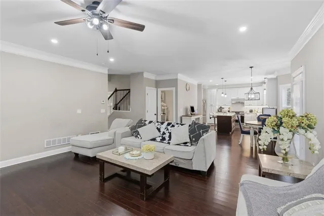 a living room with furniture and wooden floor