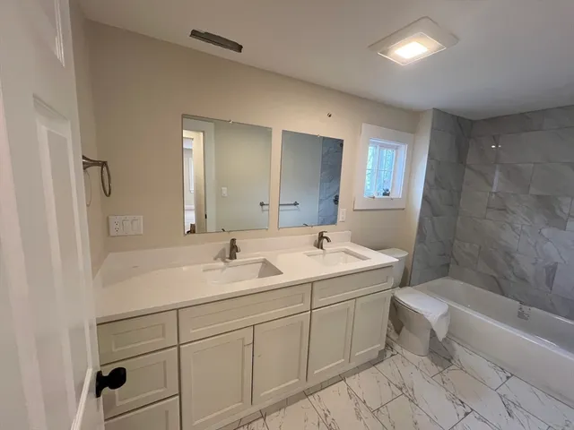 a view of bathroom with a toilet sink bath tub and shower
