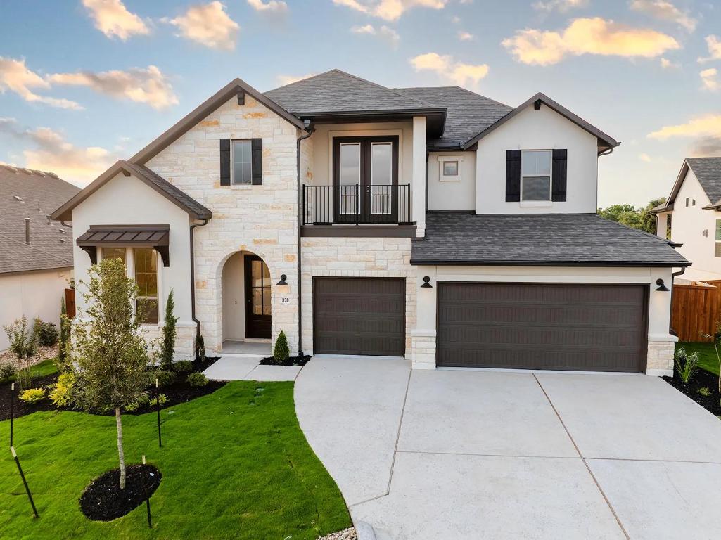 330 Bridge Water Loop Dripping Springs, TX 78620 - Photo 1 of 1 a front view of house with yard and garage