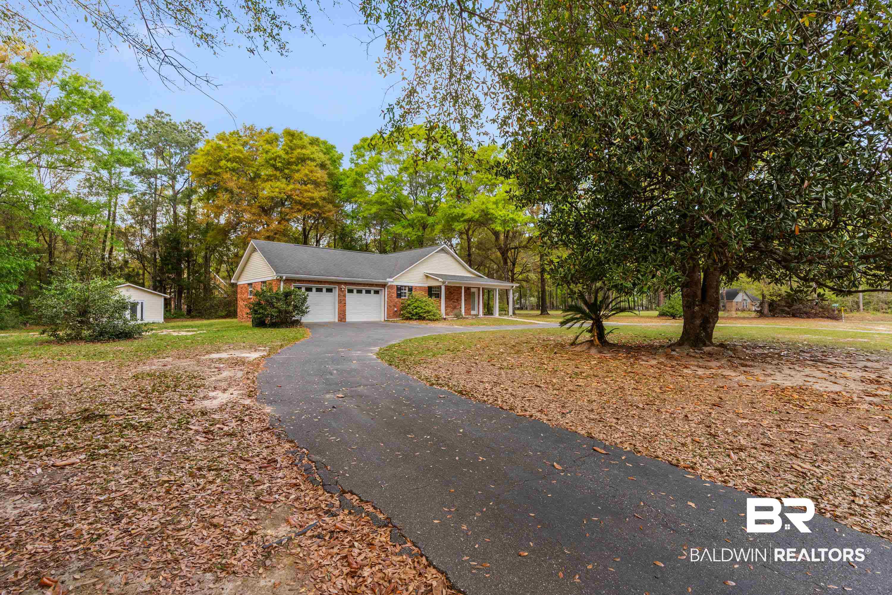 10140 Lakeview Road Bay Minette, AL 36507 - Photo 25 of 35 Ranch-style home featuring circular driveway, brick exterior, a front yard, and view of wooded area