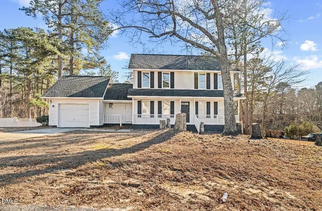 a view of a house with a yard covered in snow