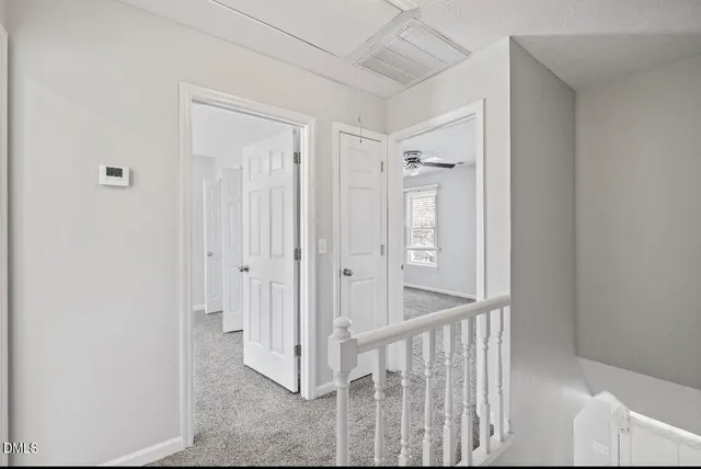 a view of a hallway with wooden shelves