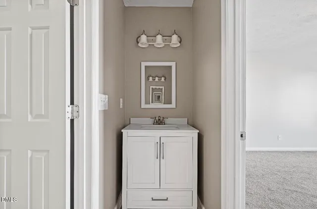 a bathroom with a granite countertop a sink and a mirror